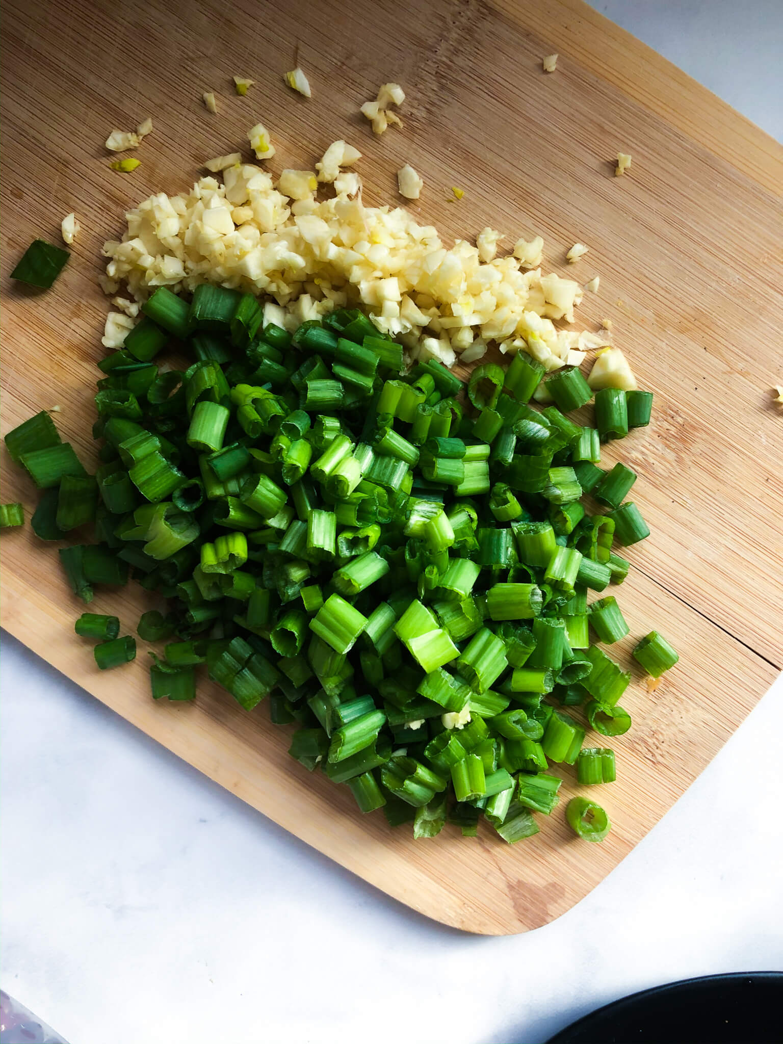 Chives and garlic on cutting board