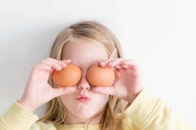 child using eggs as eyes