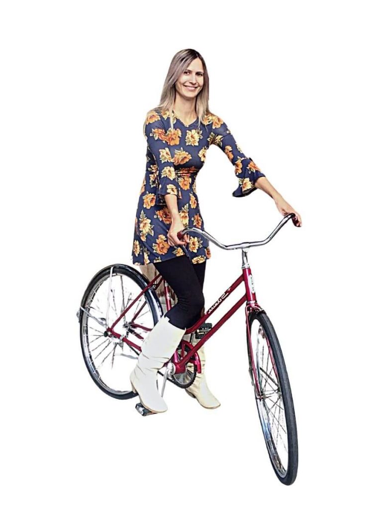 woman in flowered dress on bike
