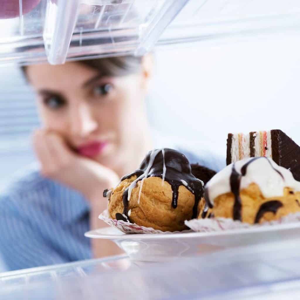 woman with disgusted face looking at pastries