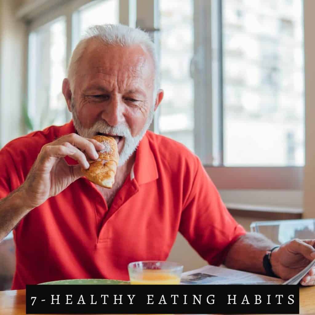 man in red shirt with white beard eating food