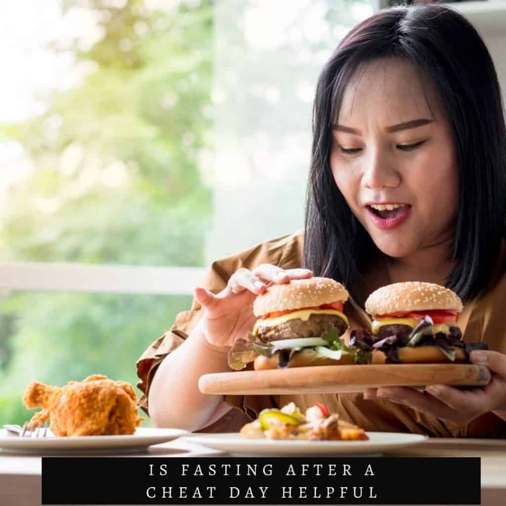 woman with two burgers on tray in front of her and fried chicken
